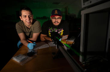 Students in lab with laser